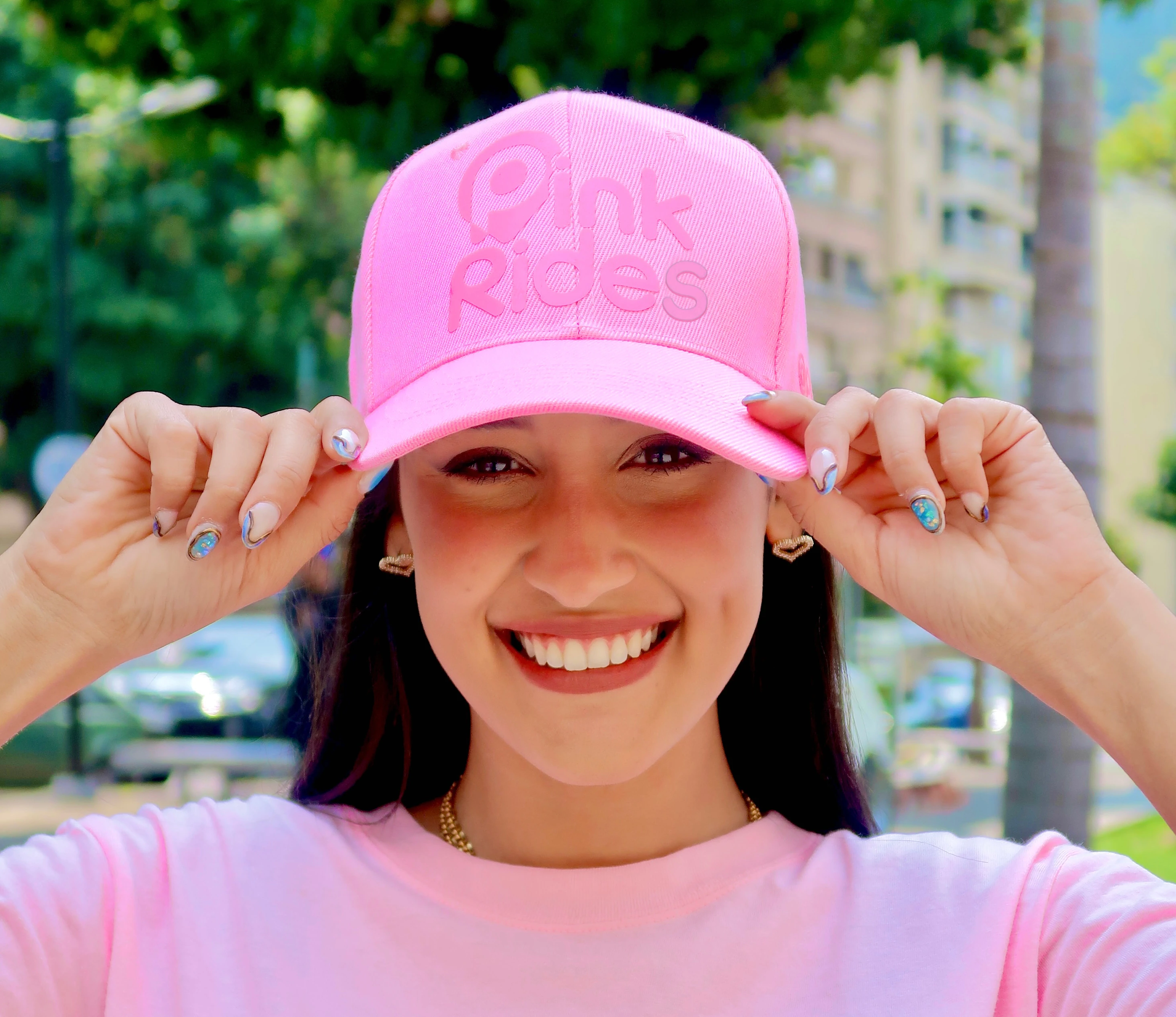 pink rides logo featuring a stylized emblem with modern typography reading pink rides; the design is set against a soft gradient urban backdrop conveying an energetic and empowering atmosphere